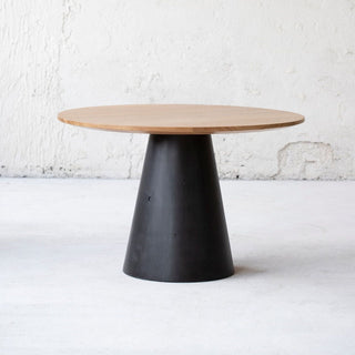 Minimalistic design dining table. Natural oak table top, concrete table base